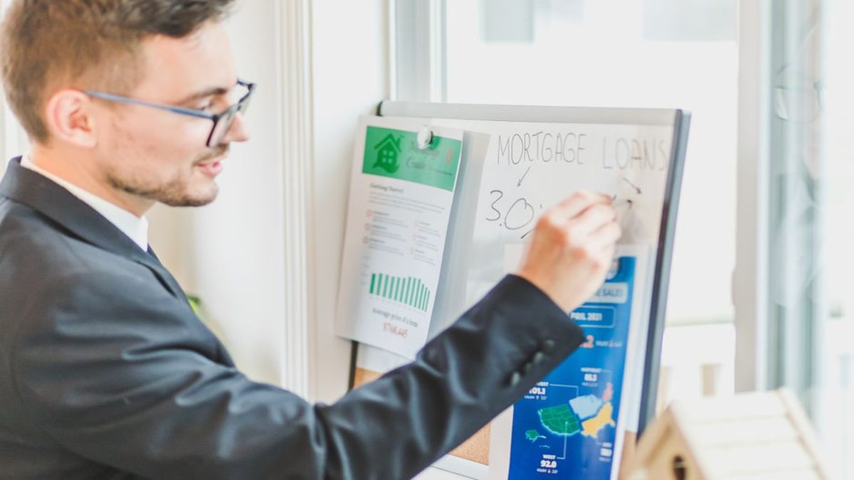 Couple reviewing home loan pre-approval documents with a mortgage broker