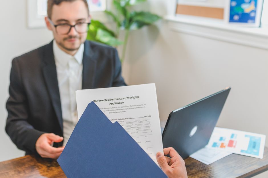Mortgage broker reviewing income documents and payslips for a pre-approval application
