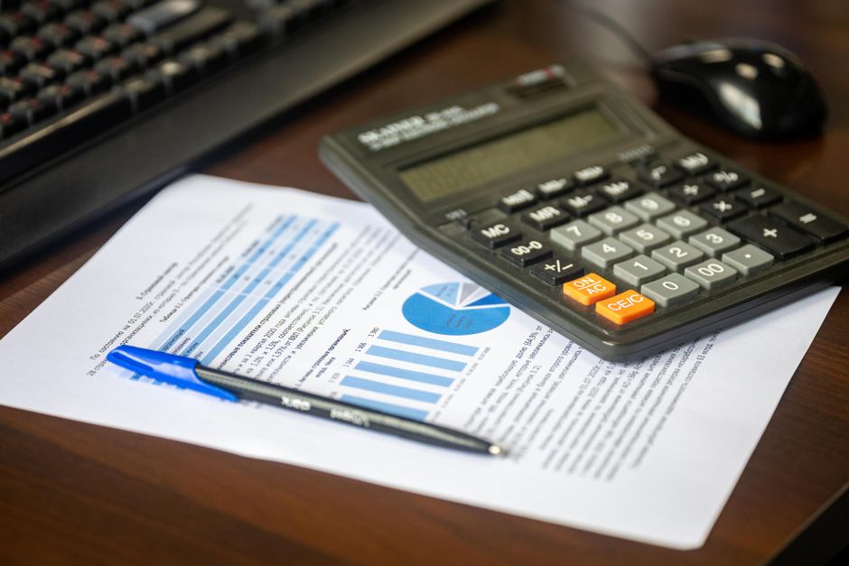 Calculator and loan documents on a desk