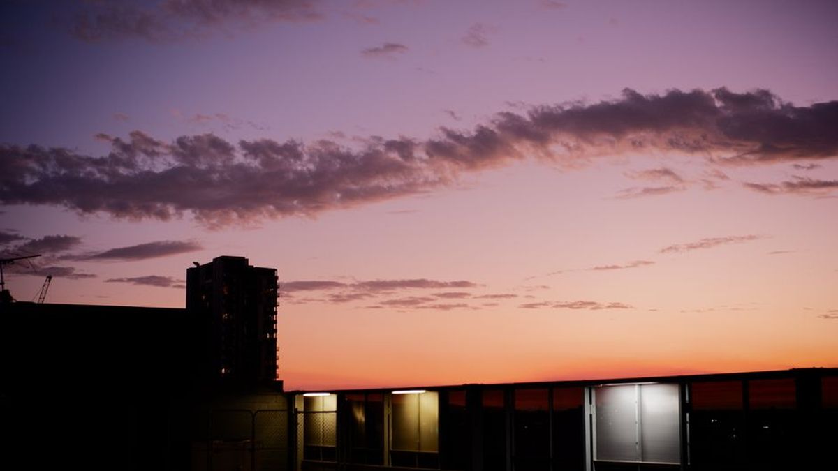 Modern Australian home exterior at sunset with a landscaped front garden
