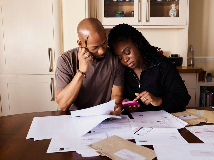 Couple reviewing home loan repayment figures together at a kitchen table