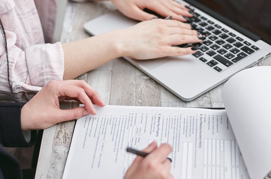 Couple reviewing home loan documents with a laptop at a table