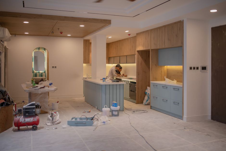 Builder working on a kitchen renovation in a home